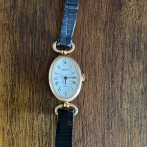 Classic Raymond Weil ladies watch with black leather band.